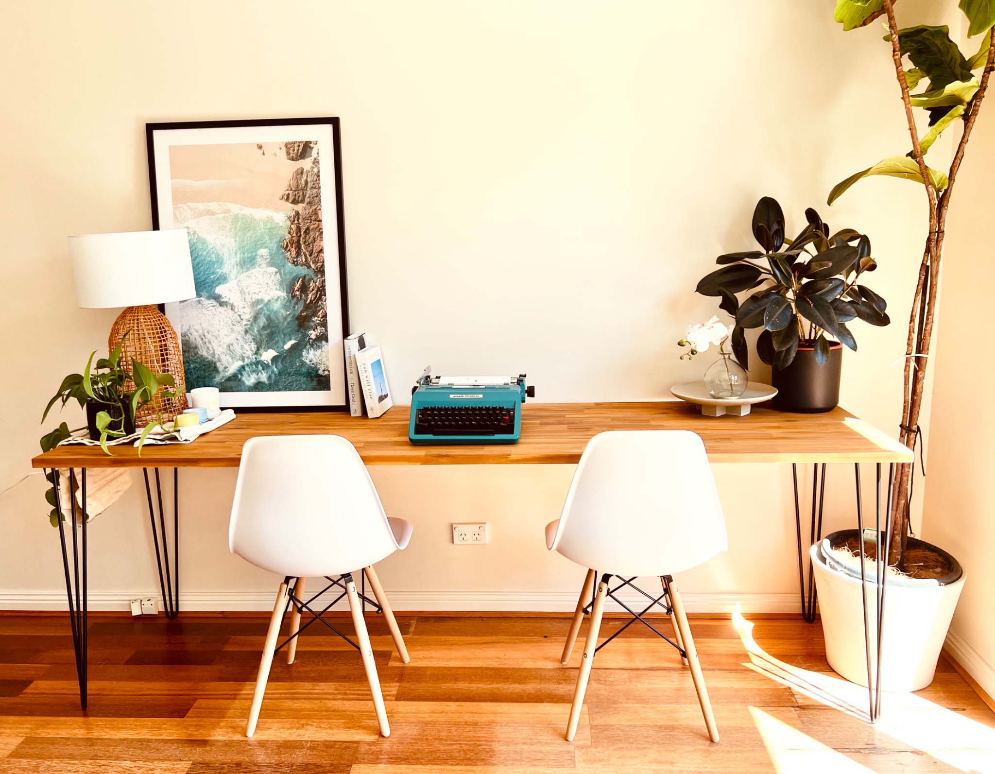 2.2m solid wood industrial table used as a long study table with two Eames chairs